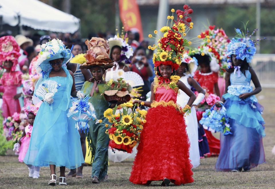 Children competing for the Easter bonnet title parade along the race track in Mount Pleasant