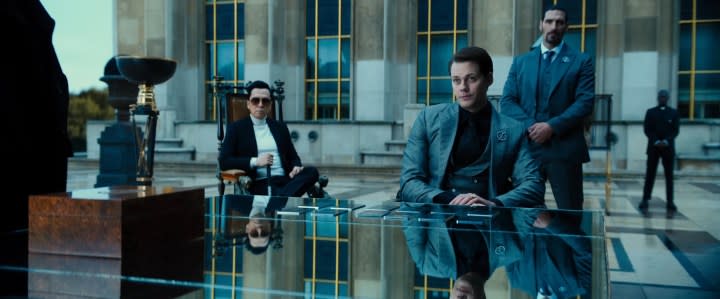 The Marquis and Caine sitting at a table in "John Wick: Chapter 4."