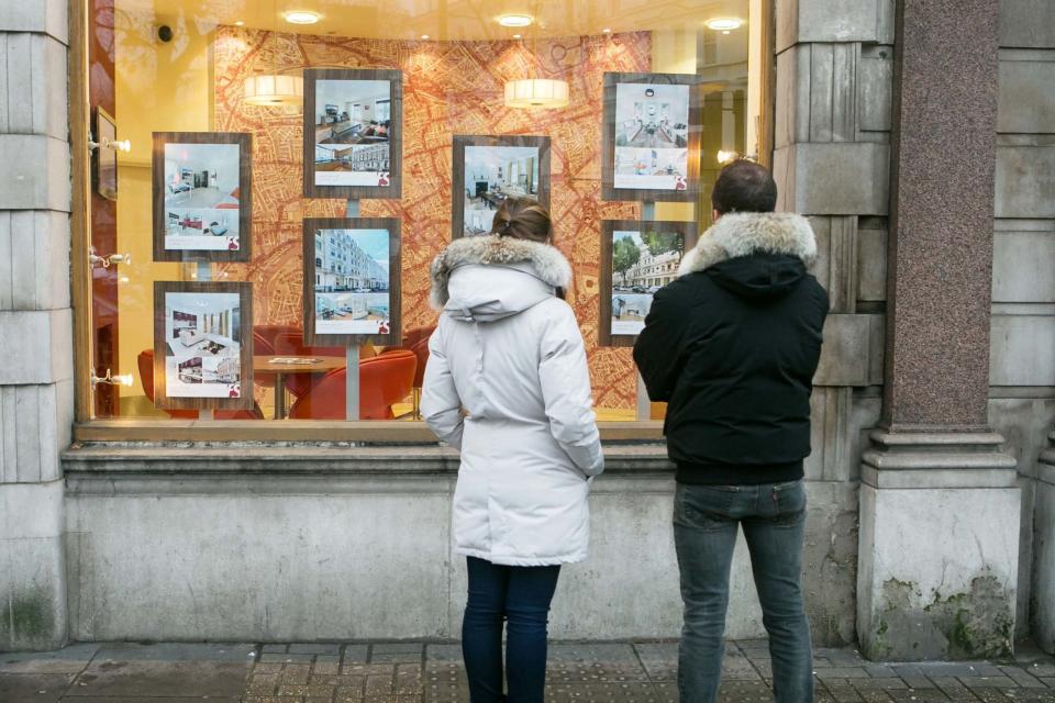 A couple looking in the window of an estate agents: PA