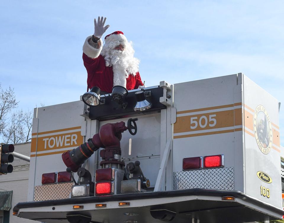 Santa waves from atop Tower 505 of the Princess Anne Volunteer Fire Company at the Princess Anne Christmas Parade Saturday, Dec. 7, 2019.
