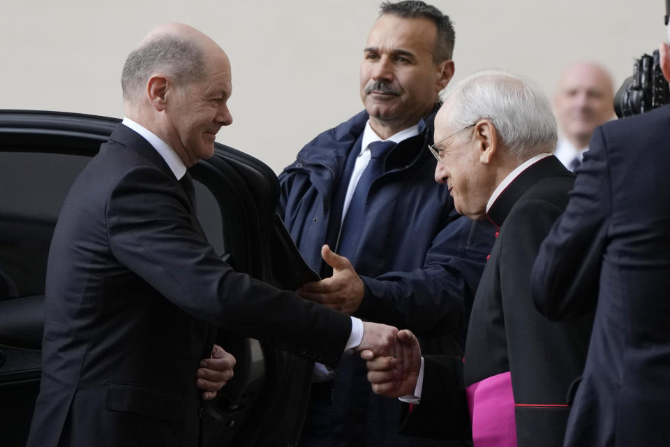 German Chancellor Olaf Scholz shakes hand with Father Leonardo Sapienza at the St. Damaso courtyard ahead of his private audience with Pope Francis at the Vatican, Saturday, March 2, 2024. (AP Photo/Alessandra Tarantino)