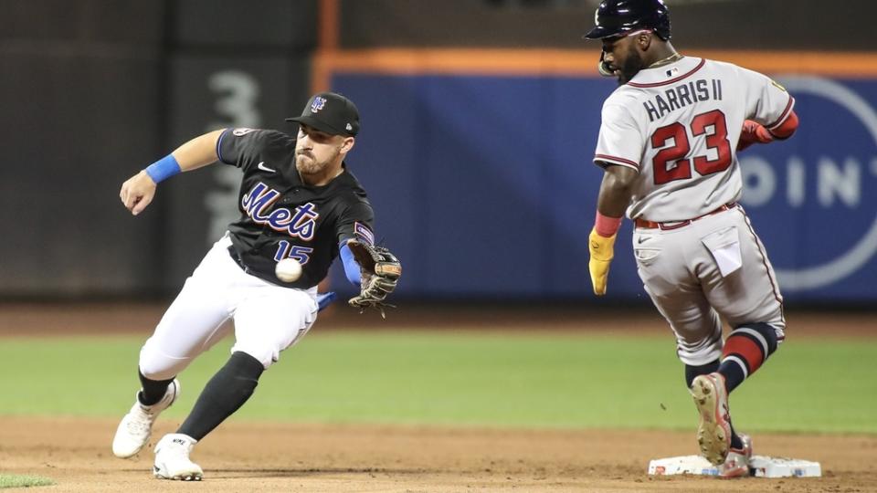 Aug 11, 2023; New York City, New York, USA; New York Mets second baseman Danny Mendick (15) saves the ball from getting past him as Atlanta Braves center fielder Michael Harris II (23) steals second base in the fifth inning at Citi Field.