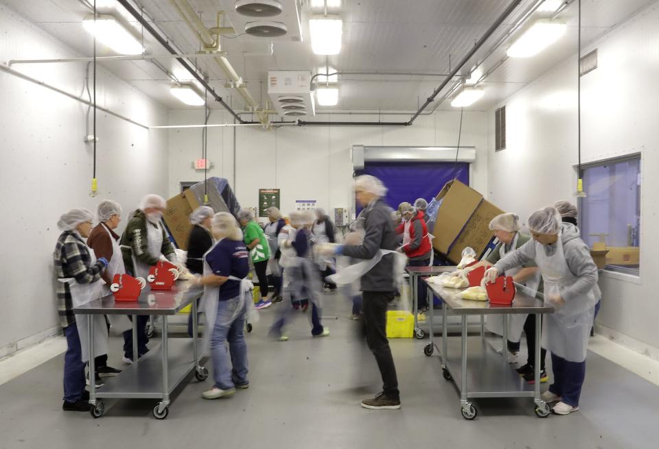 Volunteers work at Feeding America Eastern Wisconsin on Friday, October 20, 2023, in Little Chute.