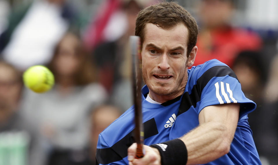 Britain's Andy Murray slams a backhand shot in his 6-1, 6-2, 6-3 victory over Donald Young in a Davis Cup tennis match on Friday, Jan. 31, 2014, in San Diego. (AP Photo/Lenny Ignelzi)
