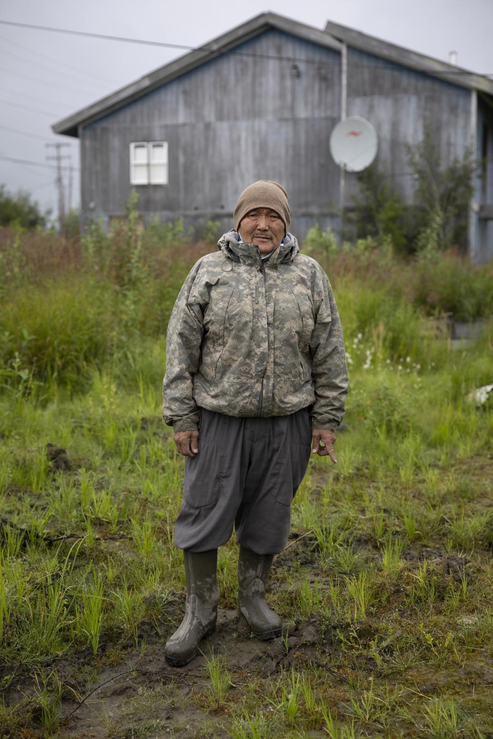 Joseph Moses poses for a portrait on Main Street, Friday, Aug. 18, 2023, in Akiachak, Alaska. Each morning, Moses collects and removes garbage and human waste from village streets. (AP Photo/Tom Brenner)