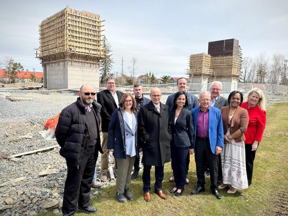 Cape Breton University president David Dingwall (centre) stands with a group of people in front of the new medical school building under construction in this April 30, 2024 file photo.