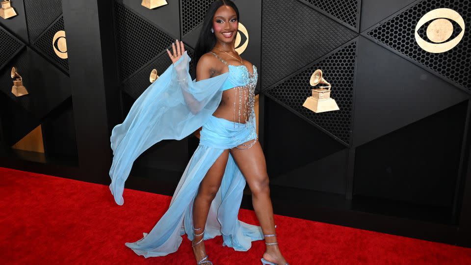 Ayra Starr, nominated for Best African Music Performance, brought some color to the red carpet in this breezy sky-blue number. - Robyn Beck/AFP/Getty Images