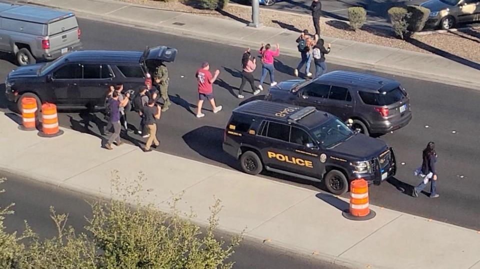 PHOTO: People leave campus with raised hands following reports of a shooting at the University of Nevada, in the campus of Las Vegas, on Dec. 6, 2023, in this screen grab taken from a handout video.  (Handout via Reuters)