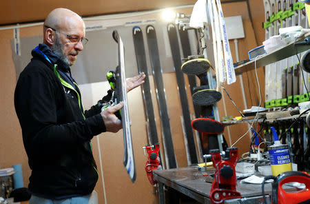 Heinz Haemmerle, or "Magic Heinzi" as US skier Lindsey Vonn calls her Austrian-born ski technician, checks the sharpness of the edges on a pair of skis of the world's most successful skiing women in his tiny waxing container at the Winter Olympics 2018 in Pyeongchang, South Korea February 19, 2018. Picture taken February 19, 2018. REUTERS/Leonhard Foeger