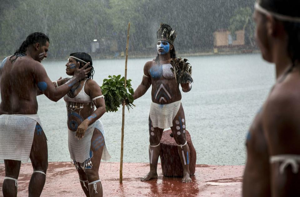 In this May 11, 2019 photo, a theatrical group performs on the Canimar River, in Matanzas, Cuba. The island contry is trying to revive businesses ranging from agriculture to textiles by turning them into part of the supply chain for the tourism business. (AP Photo/Ismael Francisco)