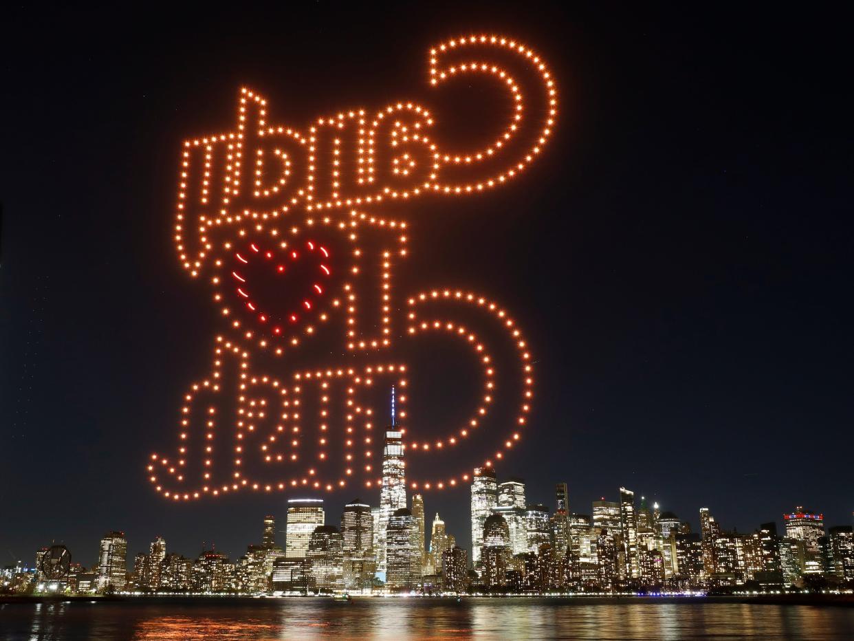 The word Candy Crush is created by 500 drones over the skyline of lower Manhattan for the 10th anniversary of the video game Candy Crush on November 3, 2022, as seen from Jersey City, New Jersey.