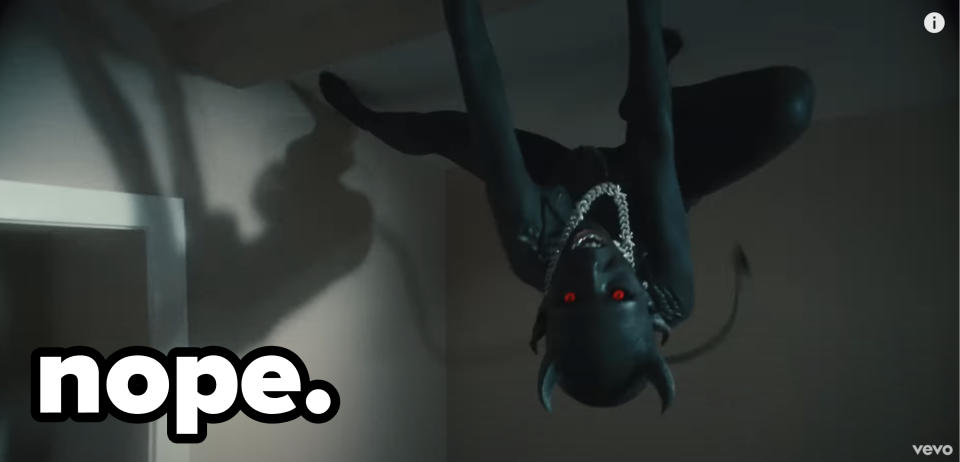 "Demon" Doja with red eyes climbing on the ceiling with caption "Nope"
