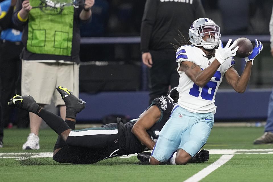 Dallas Cowboys' T.Y. Hilton makes a long ctch in front of Philadelphia Eagles' Reed Blankenship during the second half of an NFL football game Saturday, Dec. 24, 2022, in Arlington, Texas. (AP Photo/Michael Ainsworth)