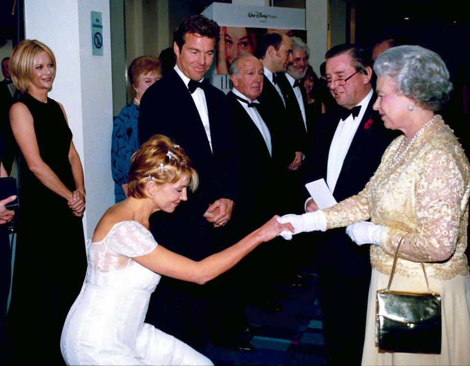 England's Queen Elizabeth II (R) meeting actress Natasha Richardson (L, curtseying) ) as actor Dennis Quaid (3L) & wife Meg Ryan (L) look on at the premiere of movie The Parent Trap .    (Photo by Ken Goff/Getty Images)