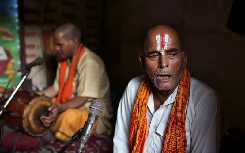 Hindu devotees sing religious songs inside a temple in Ayodhya