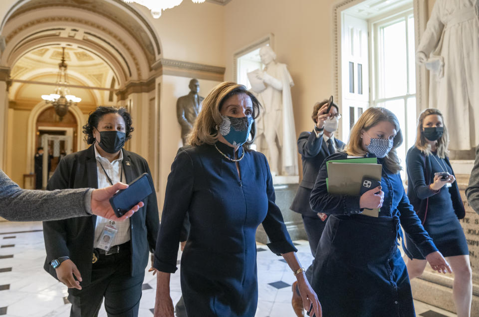 Speaker of the House Nancy Pelosi, D-Calif., returns to her leadership office after opening debate on the impeachment of President Donald Trump, at the Capitol in Washington, Wednesday, Jan. 13, 2021. The House of Representatives is pursuing an article of impeachment against Trump for his role in inciting an angry mob to storm the Capitol last week. (AP Photo/J. Scott Applewhite)