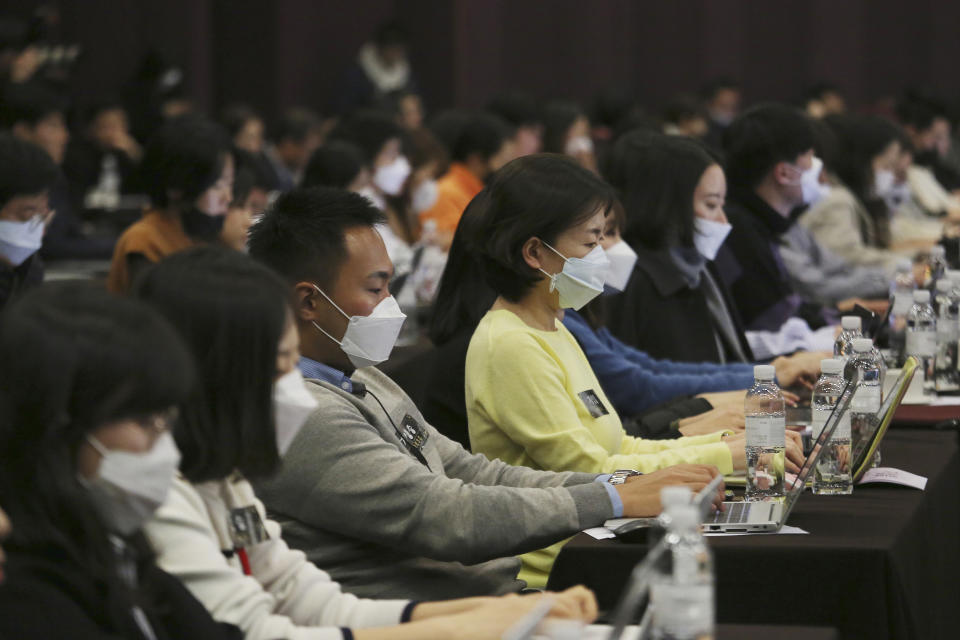 Journalists wear face masks during a press conference of Bong Joon-ho, director of Oscar-winning “Parasite,” in Seoul, South Korea, Wednesday, Feb. 19, 2020. Bong said Wednesday “the biggest pleasure and the most significant meaning” that the film has brought to him was its success in many countries though the audiences might feel uncomfortable with his explicit description of a bitter wealth disparity in modern society. (AP Photo/Ahn Young-joon)