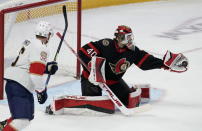 Florida Panthers center Aleksander Barkov looks on as Ottawa Senators goaltender Mads Sogaard makes a glove-save on a shot during second-period NHL hockey game action Monday, March 27, 2023, in Ottawa, Ontario. (Adrian Wyld/The Canadian Press via AP)