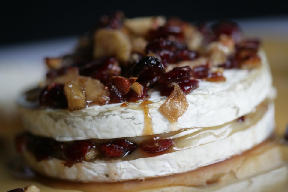 Brie makes an excellent and elegant appetizer baked with chutney, sweetened cranberries, pecans and apples.