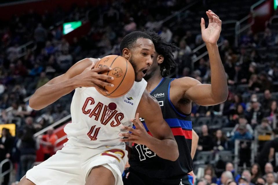 Cleveland Cavaliers forward Evan Mobley (4) runs into the defense of Detroit Pistons center James Wiseman (13) during the first half of an NBA basketball game, Friday, March 1, 2024, in Detroit. (AP Photo/Carlos Osorio)