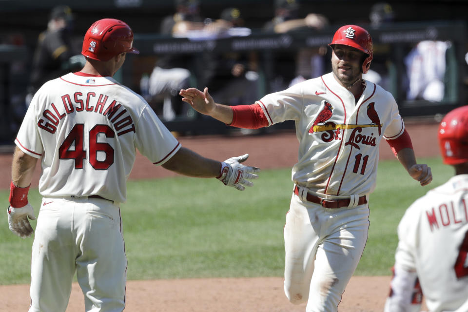 St. Louis Cardinals' Paul DeJong (11) celebrates with Paul Goldschmidt (46) after both players scored on a double by Matt Carpenter during the eighth inning of a baseball game against the Pittsburgh Pirates Saturday, July 25, 2020, in St. Louis. The Cardinals won 9-1. (AP Photo/Jeff Roberson)