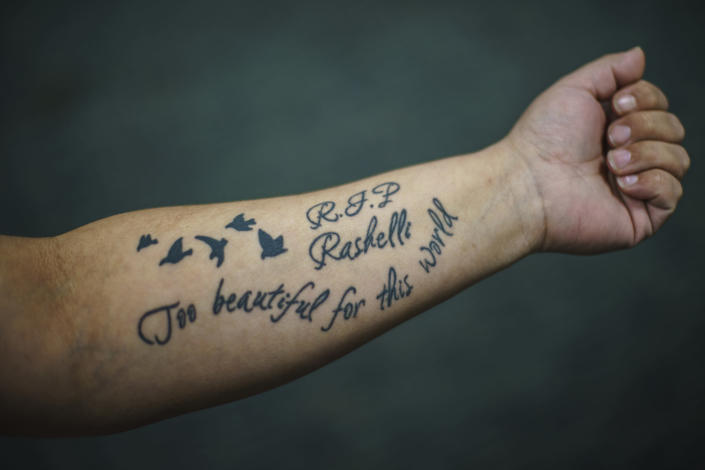 Rose Heinonen shows off a tattoo memorializing her 18-year-old friend who died of a drug overdose, as she visits the Northwest Indian Community Development Center in Bemidji, Minn., Tuesday, Nov. 16, 2021. Indian health care has been underfunded for decades. When the American government forced Native Americans off their land, it signed treaties with tribes promising to provide for them necessities like health care. The dead from addiction is proof it's never kept its word, said Minnesota Sen. Tina Smith. (AP Photo/David Goldman)