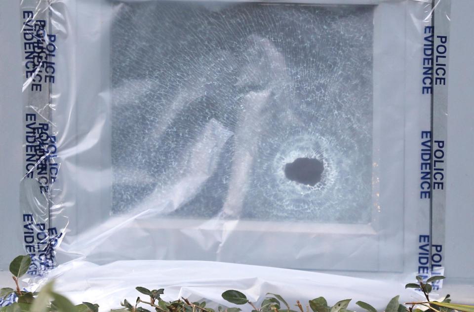 A bullet hole can be seen in the window of the Maple Tree pub (SWNS)