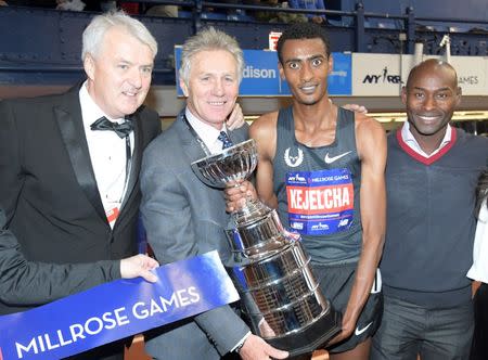 Feb 9, 2019; New York, NY, USA; Wanamaker Mile winner Yomif Kejelcha (ETH), second from right, poses with past winners Ray Flynn (IRL), left, Eamonn Coghlan (IRL), second from left, and Bernard Lagat (USA) after winning the in 3:48.46 - 0.01 off the world record of 3:48.45 set by Hicham El Guerrouj (MAR) in 1997 - during the 112th Millrose Games at The Armory. Kirby Lee-USA TODAY Sports