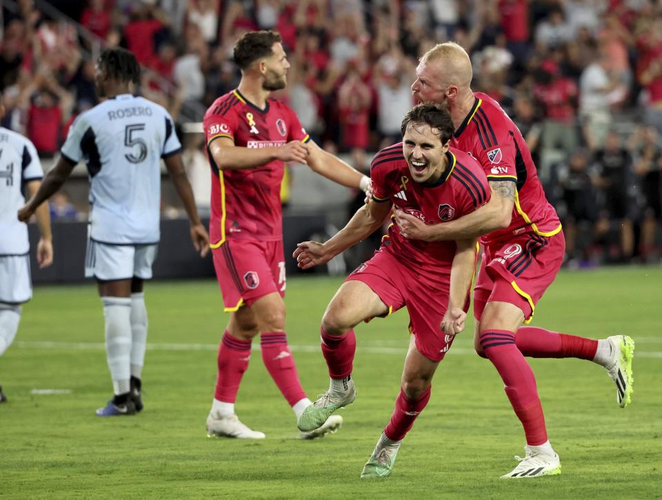 St. Louis City SC' Jared Stroud, center, and João Klauss, right, celebrate Stroud's second-half goal against Sporting Kansas City during an MLS soccer match Saturday, Sept. 30, 2023, in St. Louis. (David Carson/St. Louis Post-Dispatch via AP)