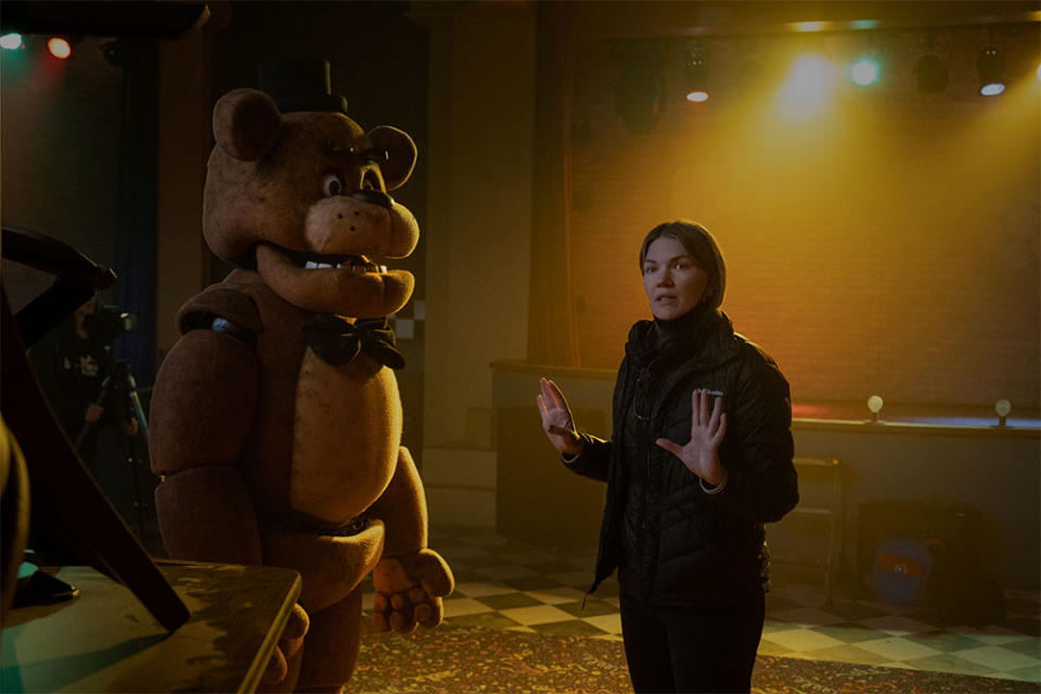 Freddy Fazbear and director Emma Tammi on the set of Five Nights at Freddy's.