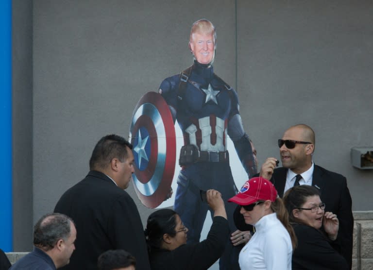 A supporter holds a cut-out of Donald Trump dressed as Captain America as he arrives for a campaign rally in Costa Mesa, California, on April 28, 2016