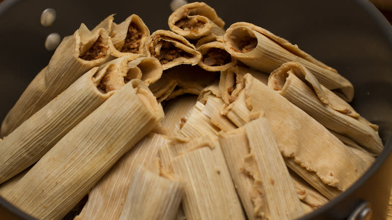 steaming tamales in pot