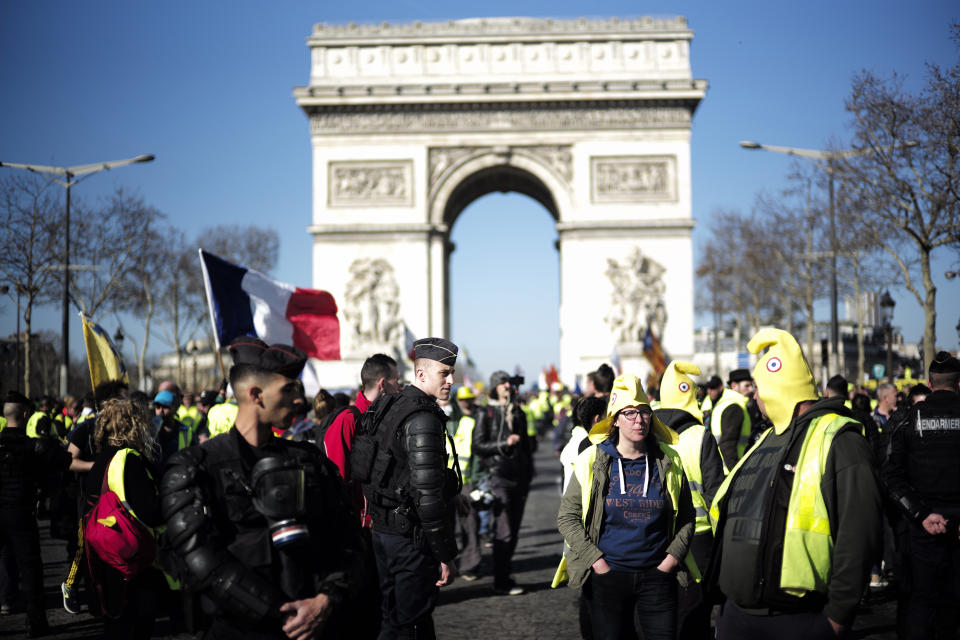 Yellow vest protesters gather at the Arc de Triomphe in Paris, France, Saturday, Feb. 23, 2019. French yellow vest protest organizers are trying to tamp down violence and anti-Semitism in the movement's ranks as they launch a 15th straight weekend of demonstrations. (AP Photo/Kamil Zihnioglu)