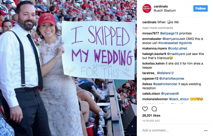 These Cardinals fans skipped out on their wedding reception. (Screenshot via @cardinals on Instagram)