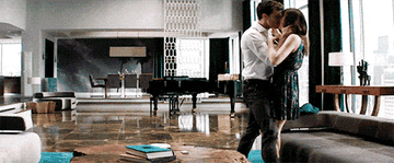 Jamie Dornan throws Dakota Johnson on a couch in 50 Shades of Grey