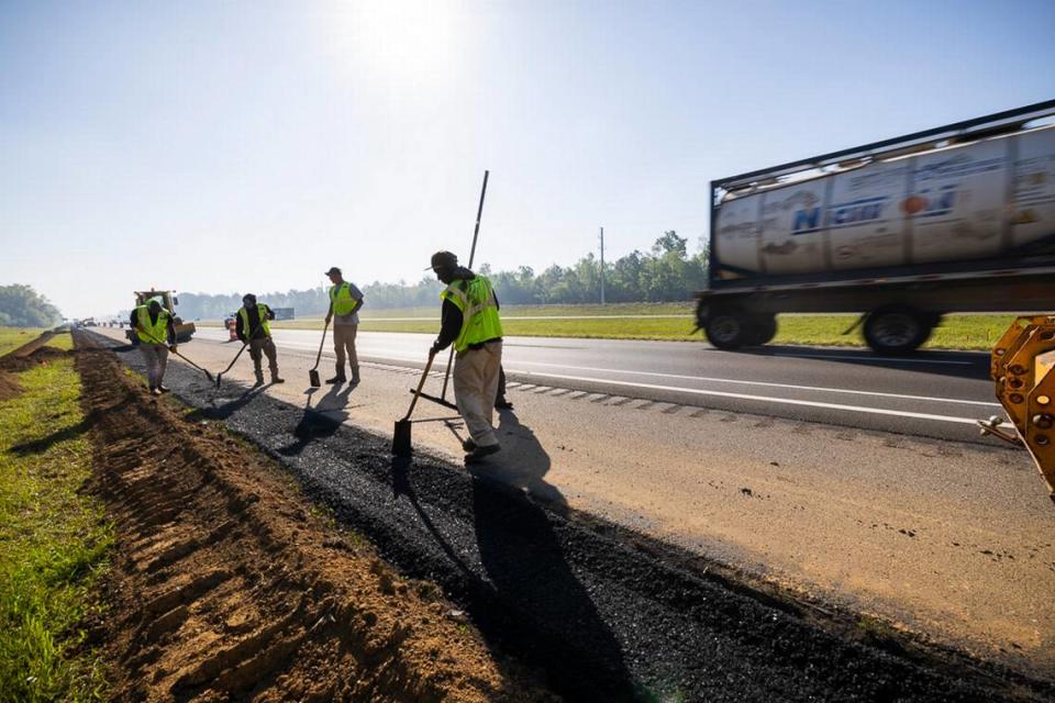 Crews pave the westbound shoulder of Interstate 10 as part of one of several construction projects in progress on the Mississippi Coast thoroughfare.