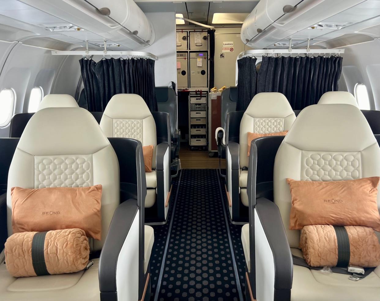 Beond's 2x2 seating layout with cream-colored seats and peach-colored linens.