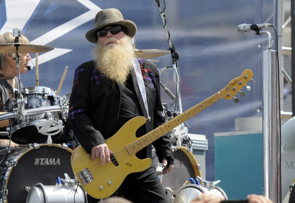 FILE - Dusty Hill, of ZZ Top, performs before the start of the NASCAR Sprint Cup series auto race in Concord, N.C., May 24, 2015. ZZ Top has announced that Hill, one of the Texas blues trio's bearded figures and bassist, has died at his Houston home. He was 72. In a Facebook post, bandmates Billy Gibbons and Frank Beard revealed Wednesday, July 28, 2021, that Hill had died in his sleep. (AP Photo/Mike McCarn, File)