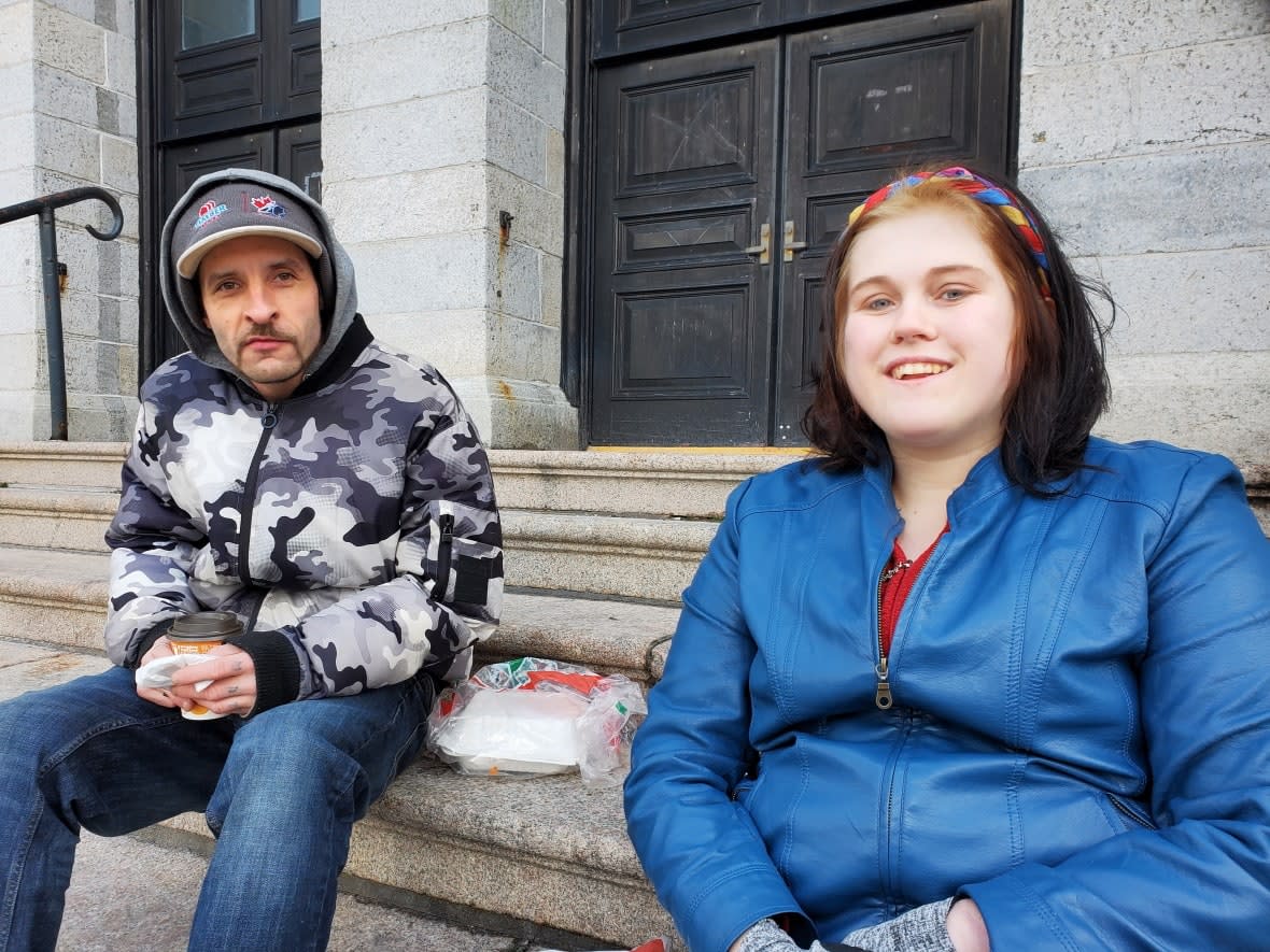 Barry Constantine and Brooklyn Howell eat lunch from the Gathering Place in St. John's. (Andrea McGuire/CBC - image credit)