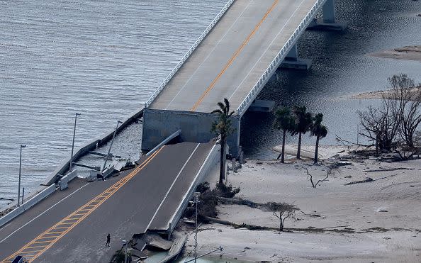 In this aerial view, the Sanibel Causeway bridge collapsed in places after Hurricane Ian passed through the area on September 29, 2022, in Sanibel, Florida.