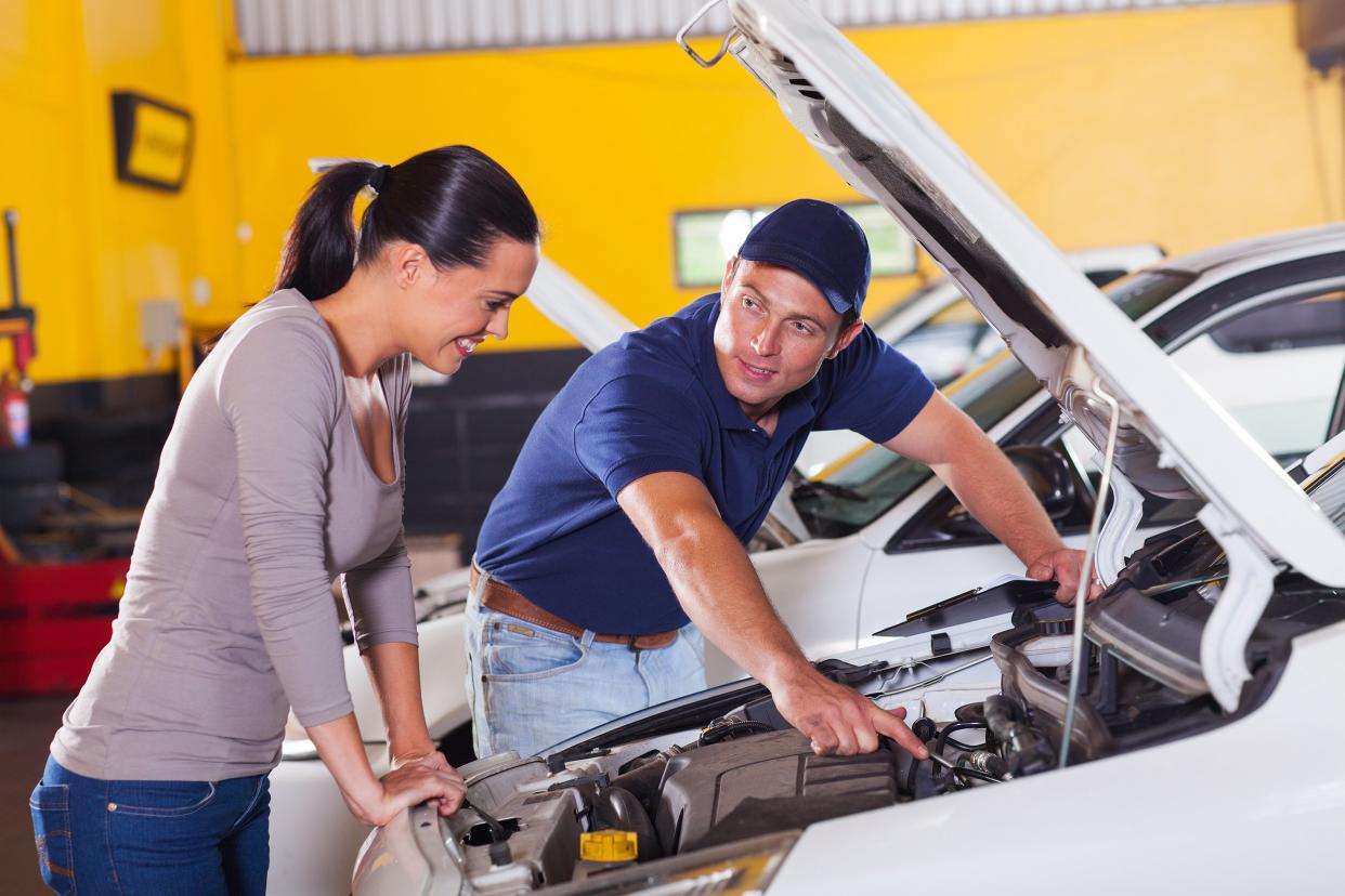 mechanic showing customer car problem