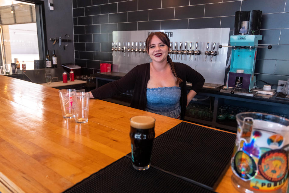 Mia Marcum, a bartender, serves with a smile at the Pondaseta Brewing Company in Amarillo.