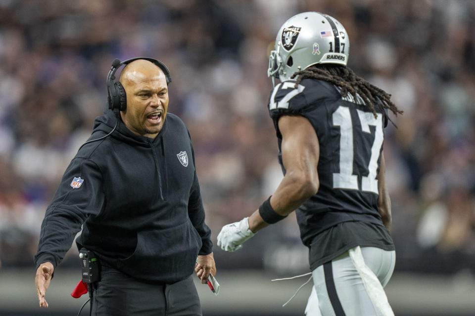 Las Vegas Raiders interim head coach Antonio Pierce (left) high-fives wide receiver Davante Adams (17). Mandatory Credit: Kyle Terada-USA TODAY Sports