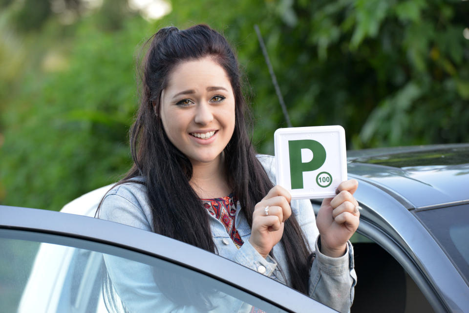 A young driver holding a green P plate. Source: Getty Images