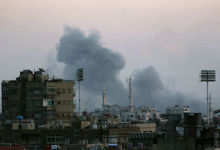 Smoke rises from Yarmouk Palestinian camp in Damascus, Syria April 21, 2018. REUTERS/Ali Hashisho