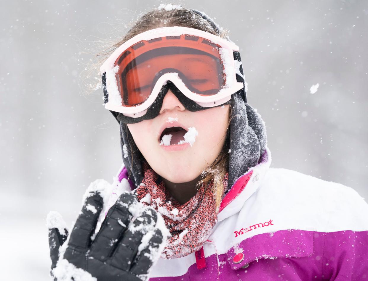 Anne Vaughan tastes the snow as she and friends enjoy sledding during a winter storm earlier this year in Nashville.