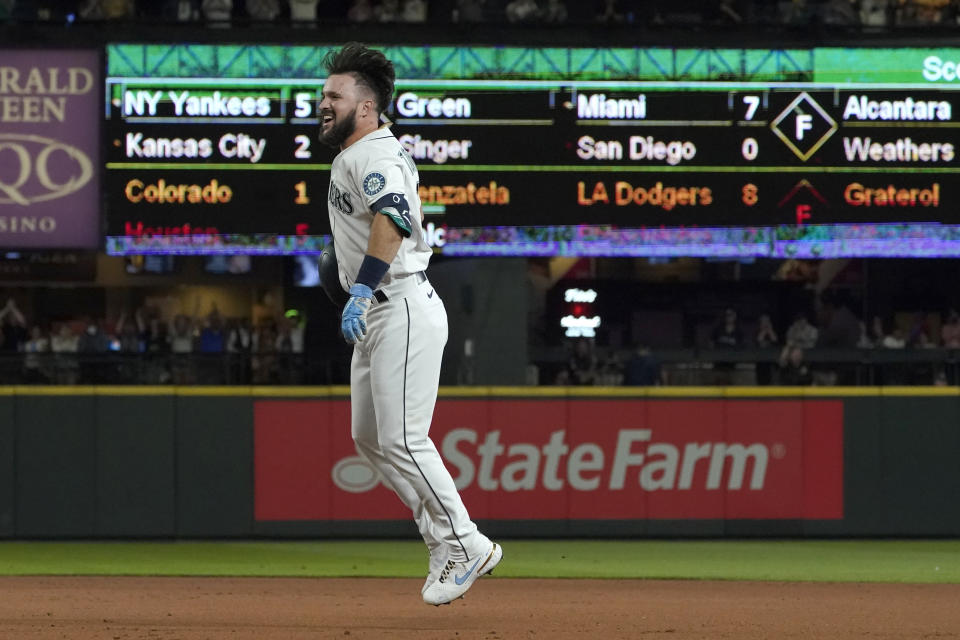 Seattle Mariners' Luis Torrens jumps after he singled to score Jarred Kelenic with the winning run off Texas Rangers pitcher Dennis Santana during the ninth inning of a baseball game Wednesday, Aug. 11, 2021, in Seattle. The Mariners won 2-1. (AP Photo/Ted S. Warren)