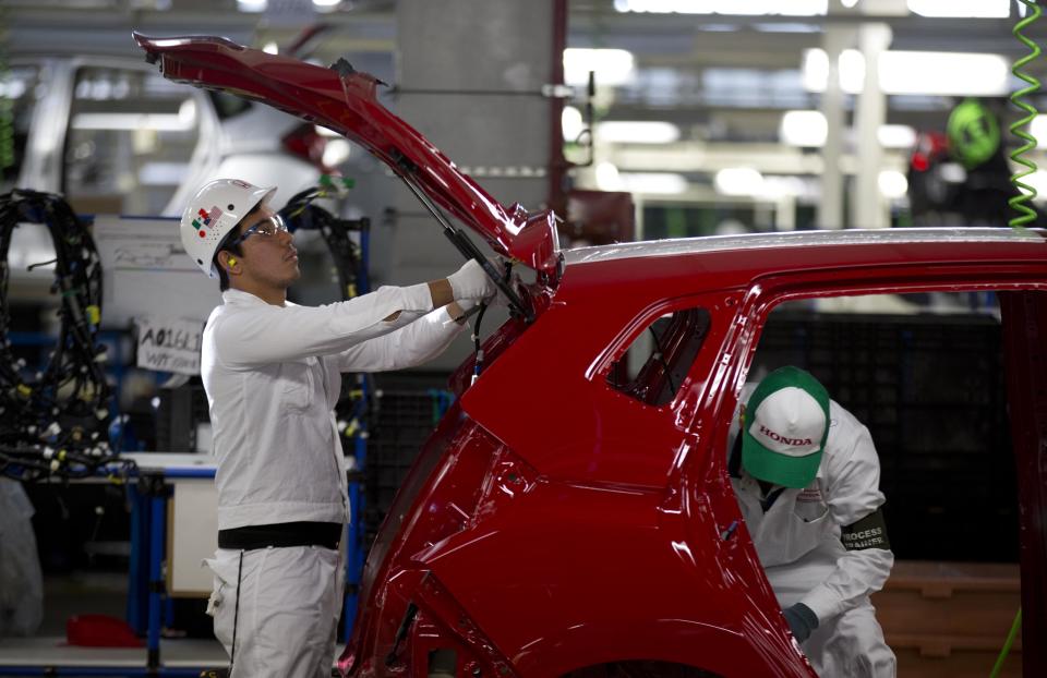 Employees at work in the new multibillion-dollar Honda car plant in Celaya, in the central Mexican state of Guanajuato, Friday, Feb. 21, 2014. Mexico is on track to overtake Japan and Canada and become the United States' No. 1 source of imported cars by the end of next year, part of a national manufacturing boom that has turned the auto industry into a bigger source of dollars than money sent home by migrants. (AP Photo/Eduardo Verdugo)