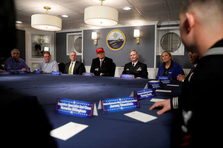 President Trump and Defense Secretary James Mattis receive a briefing with Commanding Officer U.S. Navy Captain Rick McCormack (2nd R) and Susan Ford Bales (R) aboard the pre-commissioned U.S. Navy aircraft carrier Gerald R. Ford. REUTERS/Jonathan Ernst
