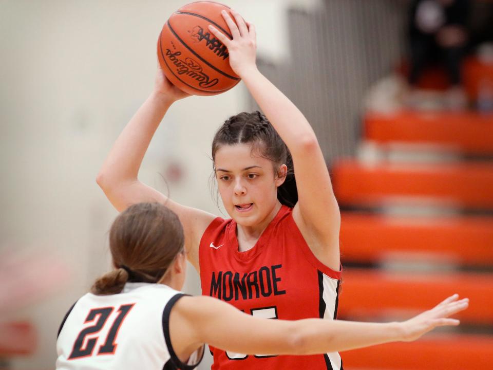 Monroe’s Sophia Bussell sizes up the defense from Madison Morris of Tecumseh Tuesday night in the girls basketball season opener for both schools.